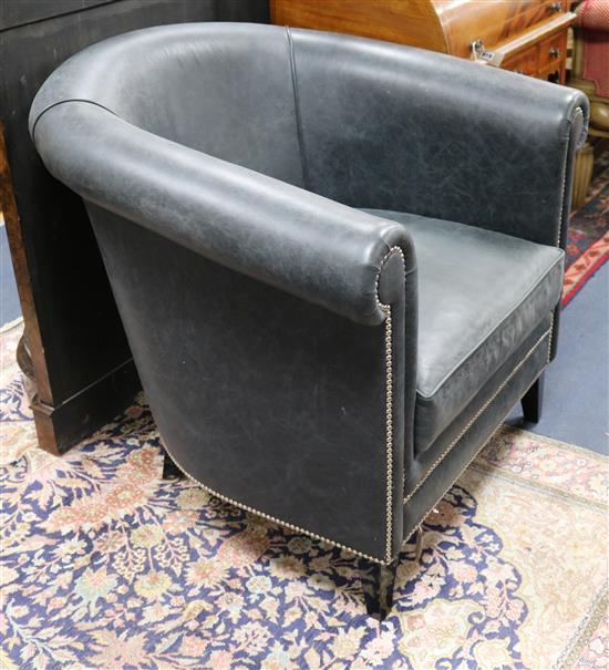 A modern black leather tub chair